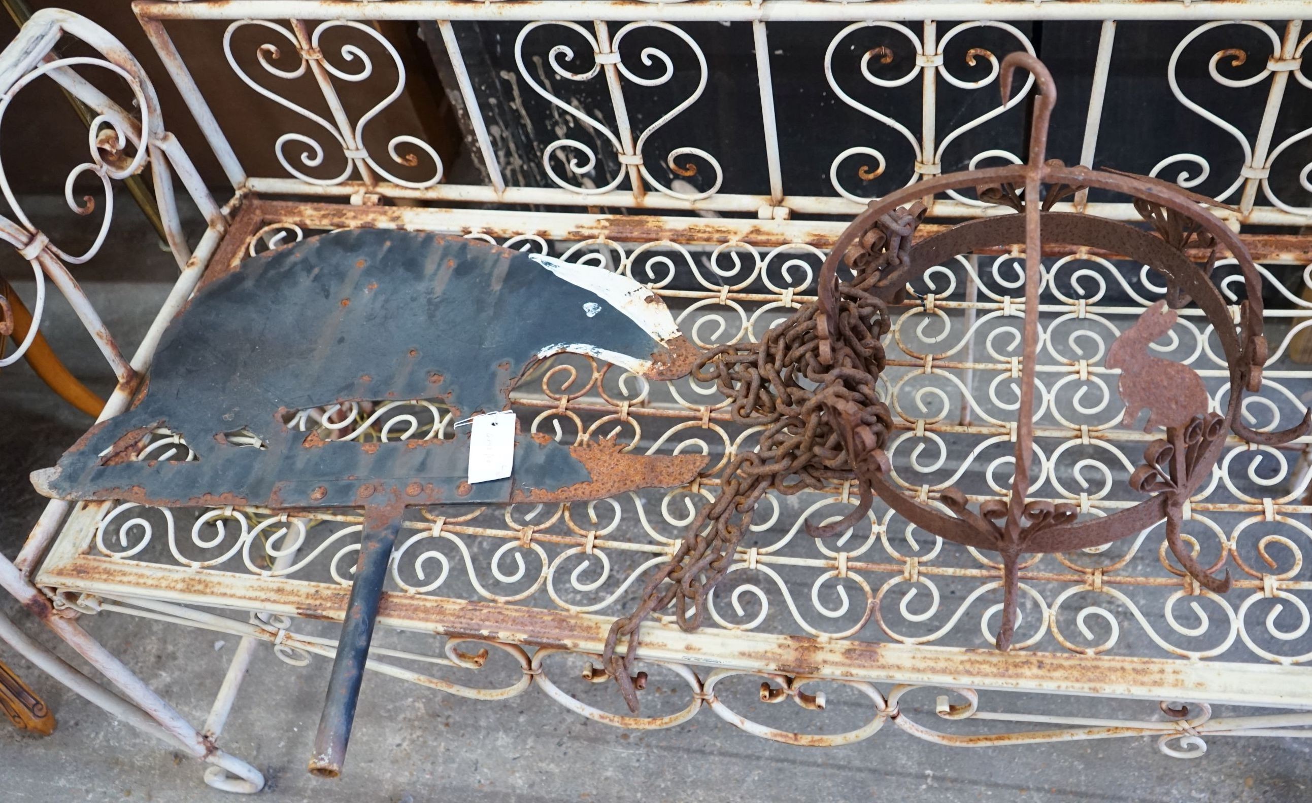 A circular wrought iron pot hanger together with a painted metal 'badger' weather vane, length 58cm